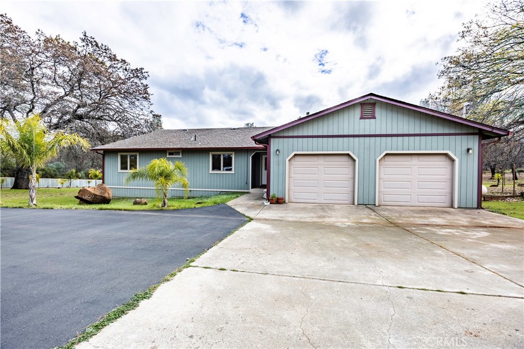 18501 Rustic Ridge Lower Lake, CA 95457 - Photo 3 of 46 a front view of a house with a garden and garage