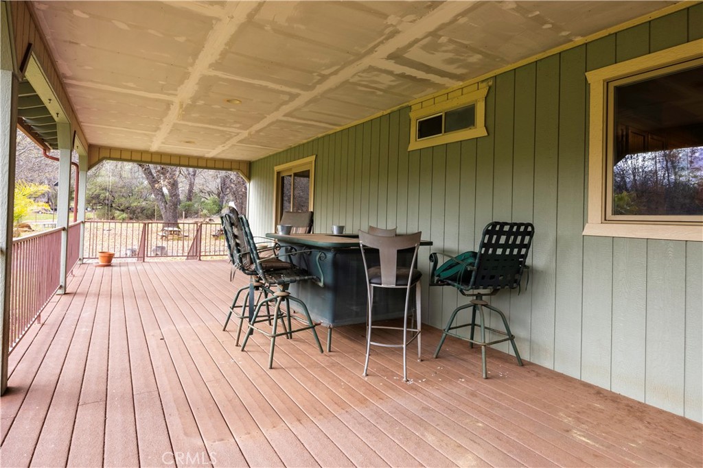 18501 Rustic Ridge Lower Lake, CA 95457 - Photo 34 of 46 a view of a patio with table and chairs with wooden floor