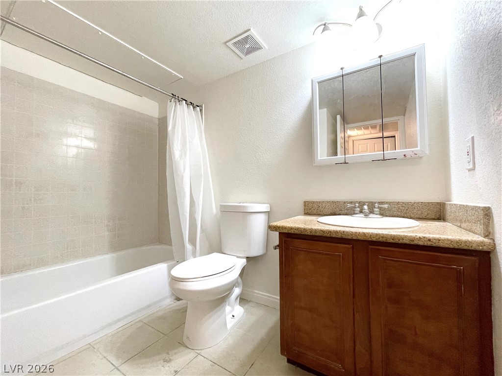 3135 South Mojave Road, Unit 221 Las Vegas, NV 89121 - Photo 16 of 19 Functional bathroom features a clean tub-shower combination, a standard toilet, and a vanity with a counter and storage.