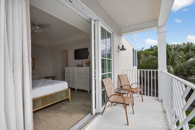 a view of a balcony with wooden floor and fence