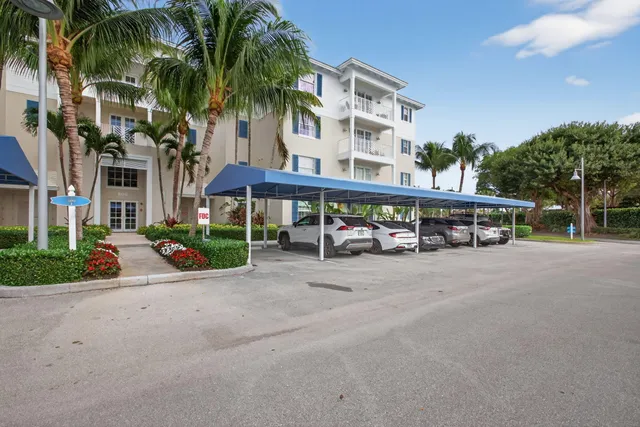 front view of a house with a yard and potted plants