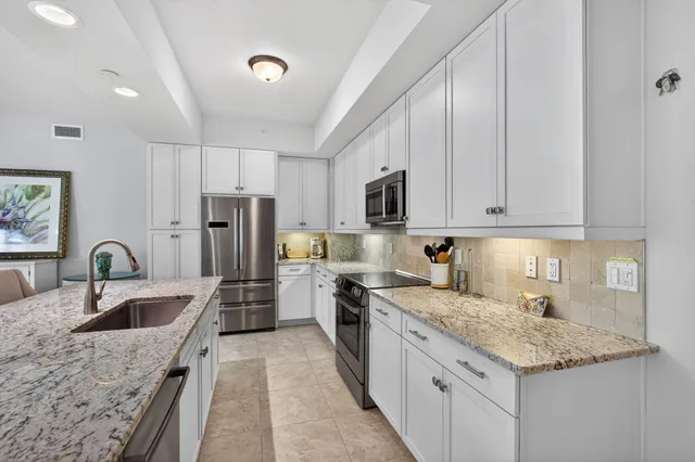 a kitchen with refrigerator and cabinets