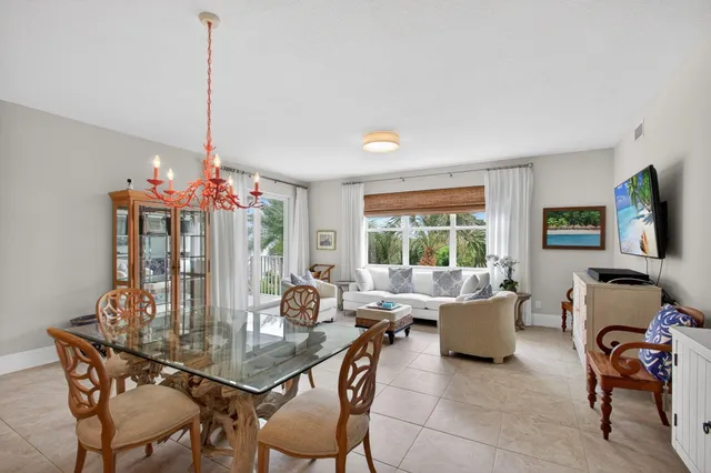 a dining room with furniture a window and a chandelier