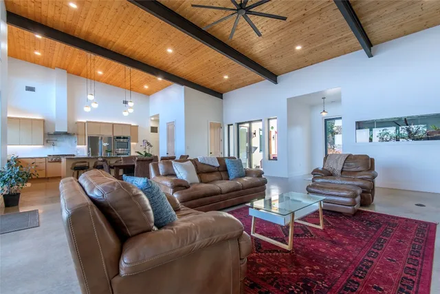 a living room with furniture a wooden floor and a chandelier
