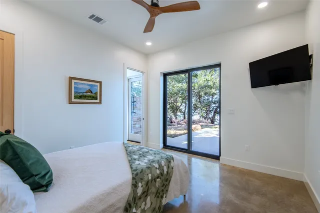 a bedroom with a bed and a television