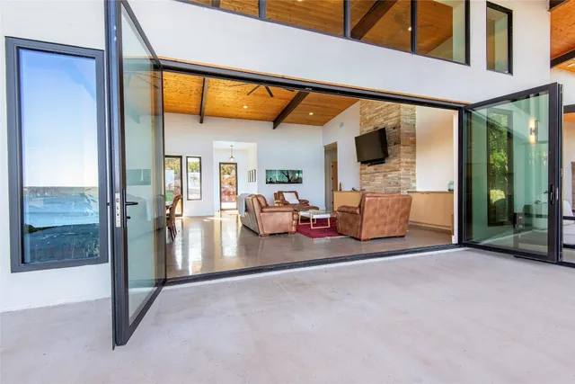 a view of a porch with a floor to ceiling window and a yard