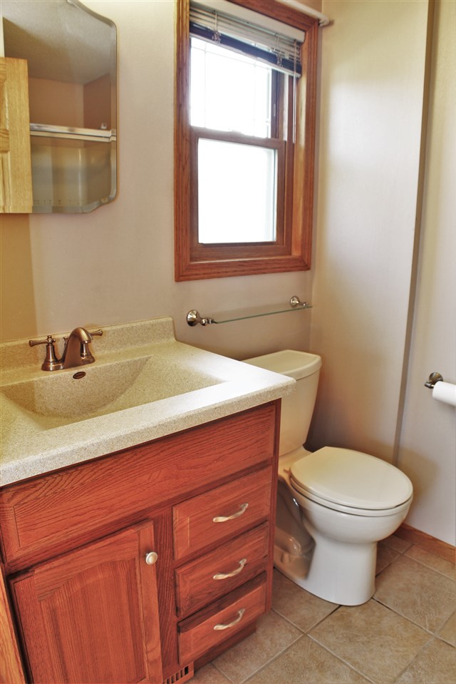308 Pembroke Road Southwest Poplar Grove, IL 61065 - Photo 13 of 25 a bathroom with a sink and a toilet