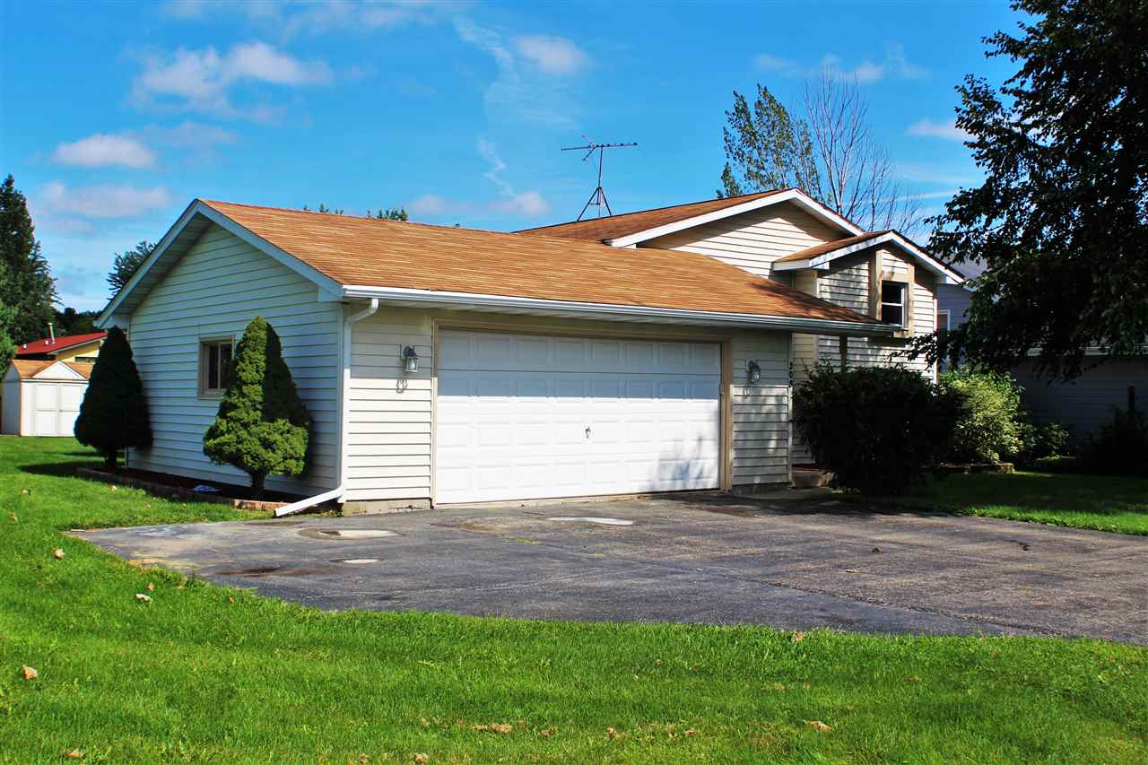 308 Pembroke Road Southwest Poplar Grove, IL 61065 - Photo 2 of 25 a front view of a house with a yard and garage