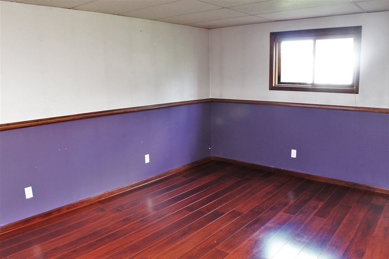 308 Pembroke Road Southwest Poplar Grove, IL 61065 - Photo 21 of 25 a view of an empty room with wooden floor and a window