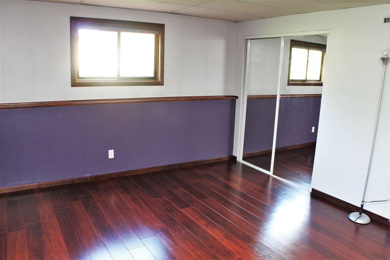 308 Pembroke Road Southwest Poplar Grove, IL 61065 - Photo 22 of 25 an empty room with wooden floor and windows