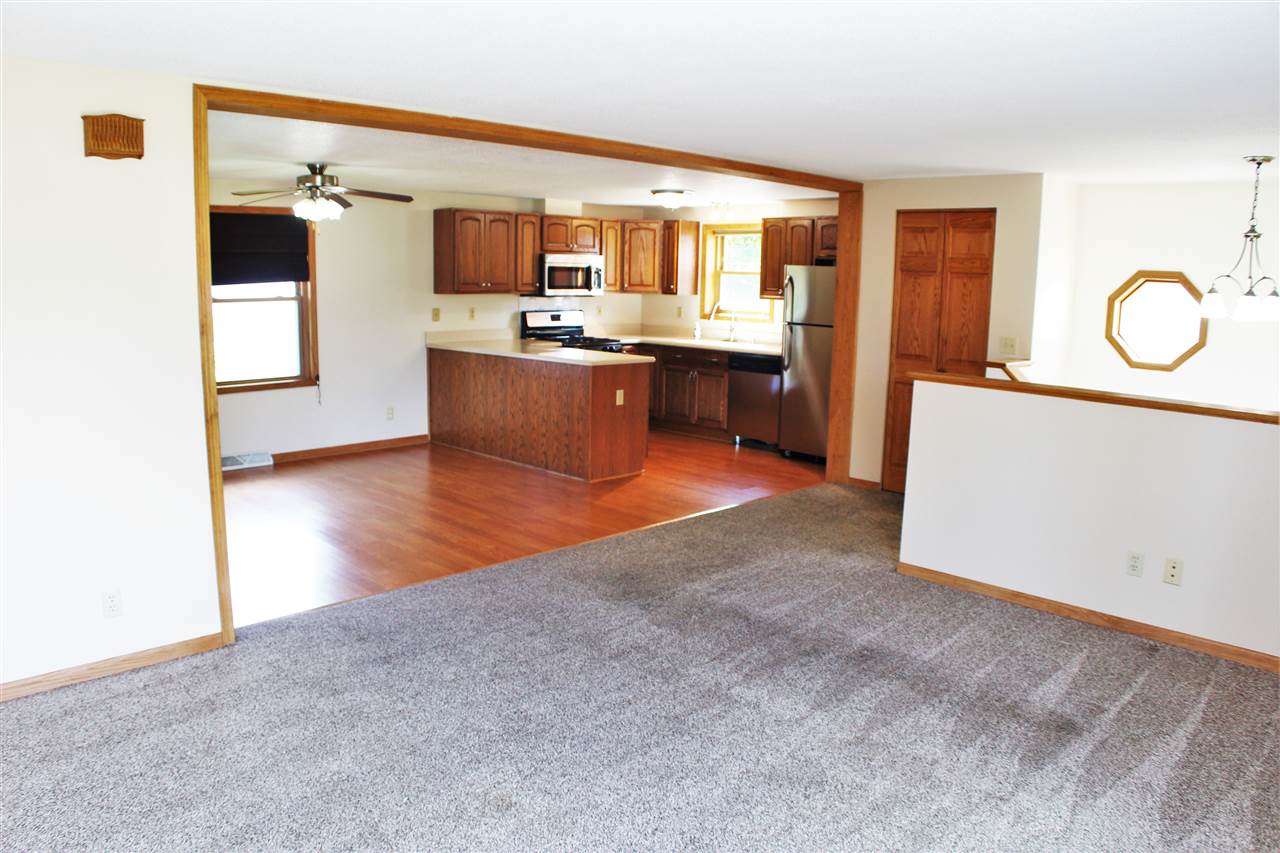 308 Pembroke Road Southwest Poplar Grove, IL 61065 - Photo 5 of 25 a living room with stainless steel appliances granite countertop furniture and a kitchen view