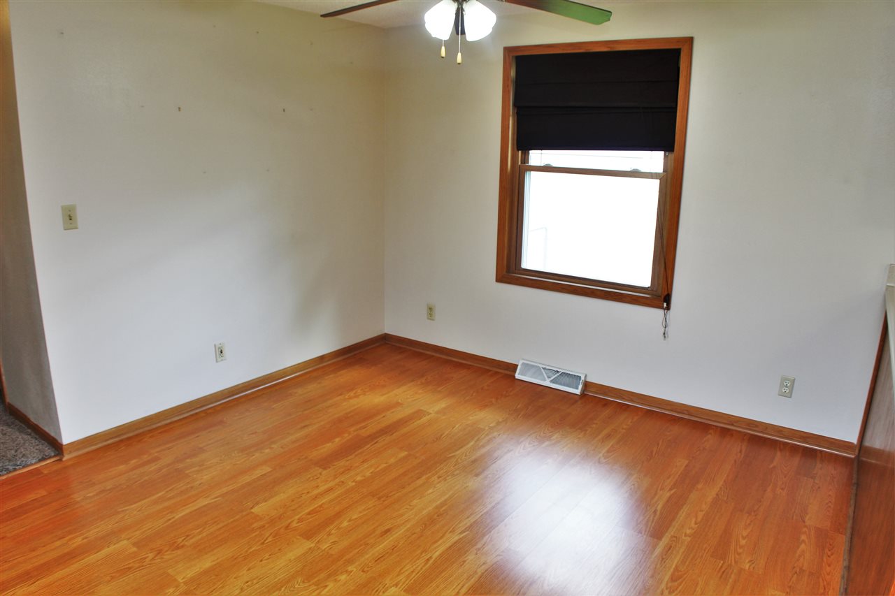 308 Pembroke Road Southwest Poplar Grove, IL 61065 - Photo 8 of 25 an empty room with a windows and wooden floor
