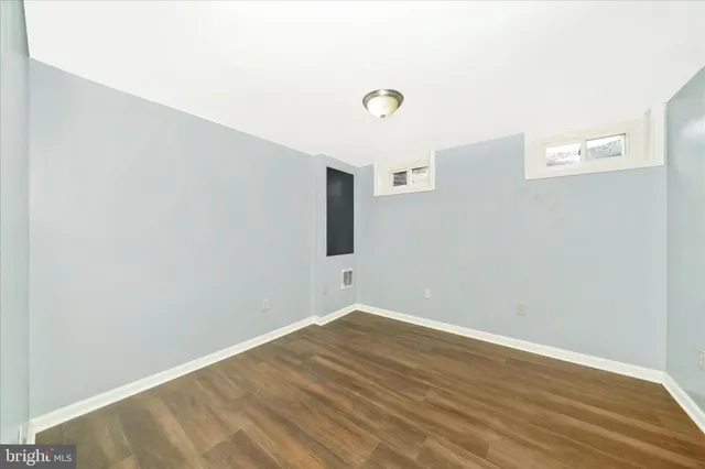 a view of a room with wooden floor and fan