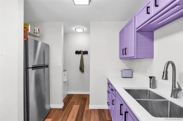 a kitchen with stainless steel appliances granite countertop a refrigerator and a sink