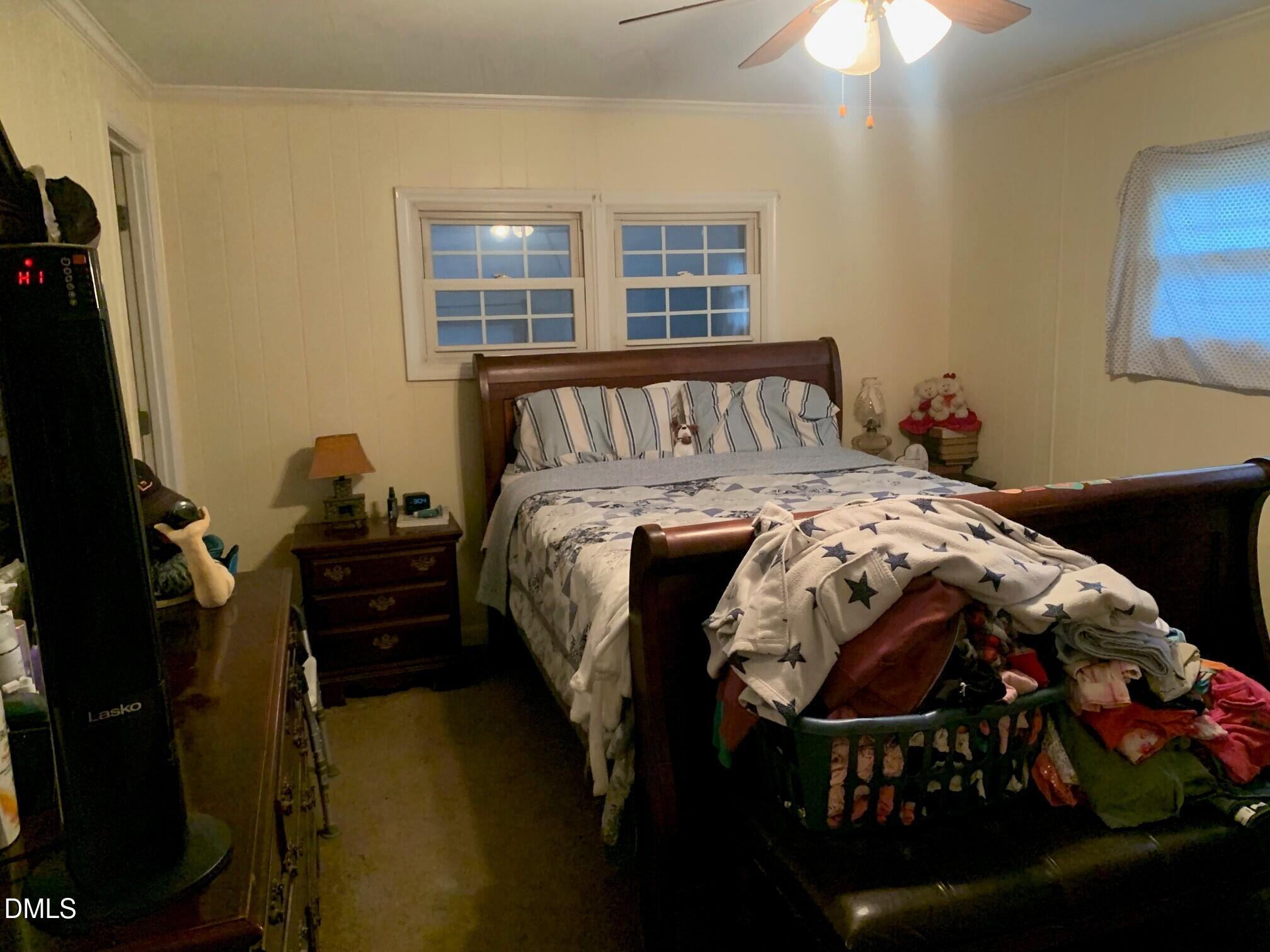 715 Patterson Road Durham, NC 27704 - Photo 5 of 18 a bedroom with a bed and a window