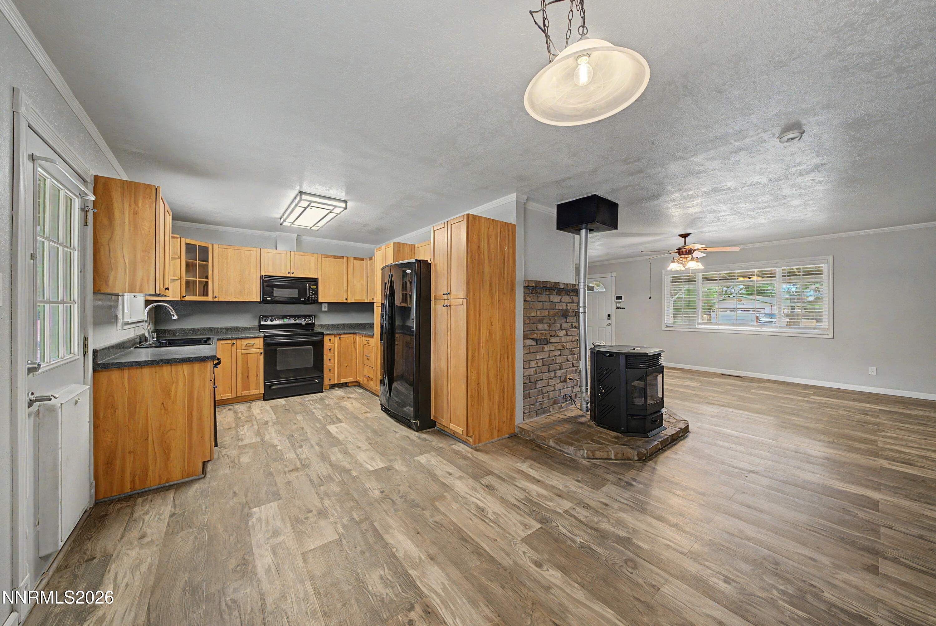 11577 Deodar Way Reno, NV 89506 - Photo 2 of 58 a kitchen with stainless steel appliances granite countertop a refrigerator a stove a sink dishwasher and a refrigerator with wooden floor