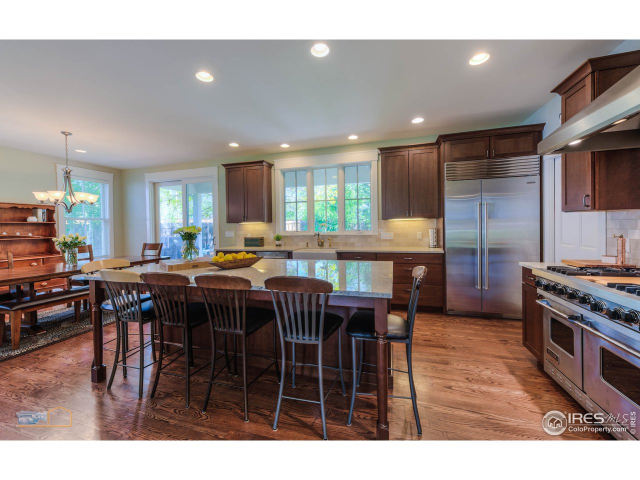 1799 Oak Avenue Boulder, CO 80304 - Photo 6 of 38 a kitchen with stainless steel appliances granite countertop a stove a refrigerator a sink a dining table and chairs