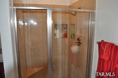 1415 Calle Monclova Rio Rico, AZ 85648 - Photo 4 of 16 a bathroom with a glass shower door