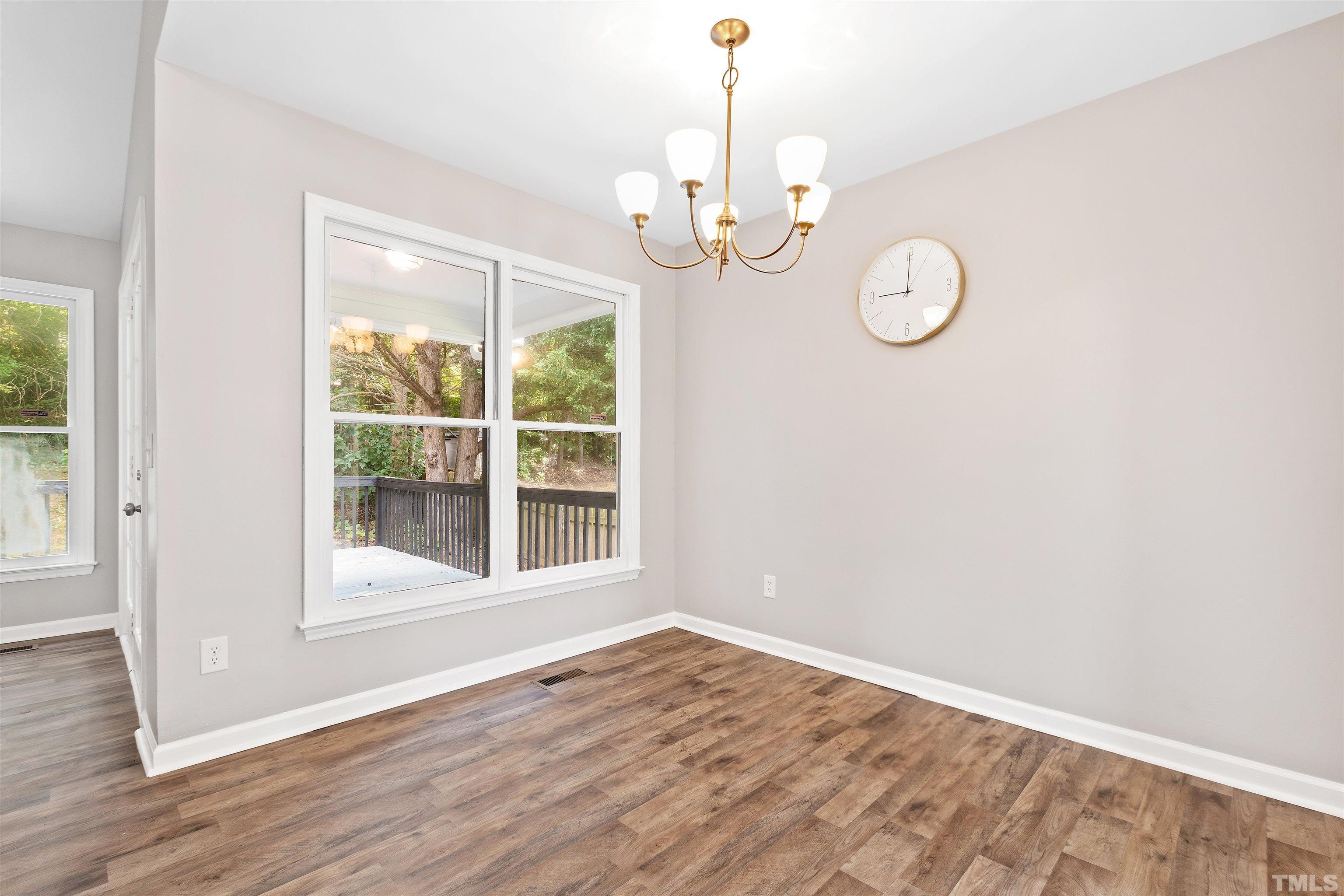 2109 Cardhu Way Raleigh, NC 27603 - Photo 19 of 40 a view of empty room with wooden floor and window