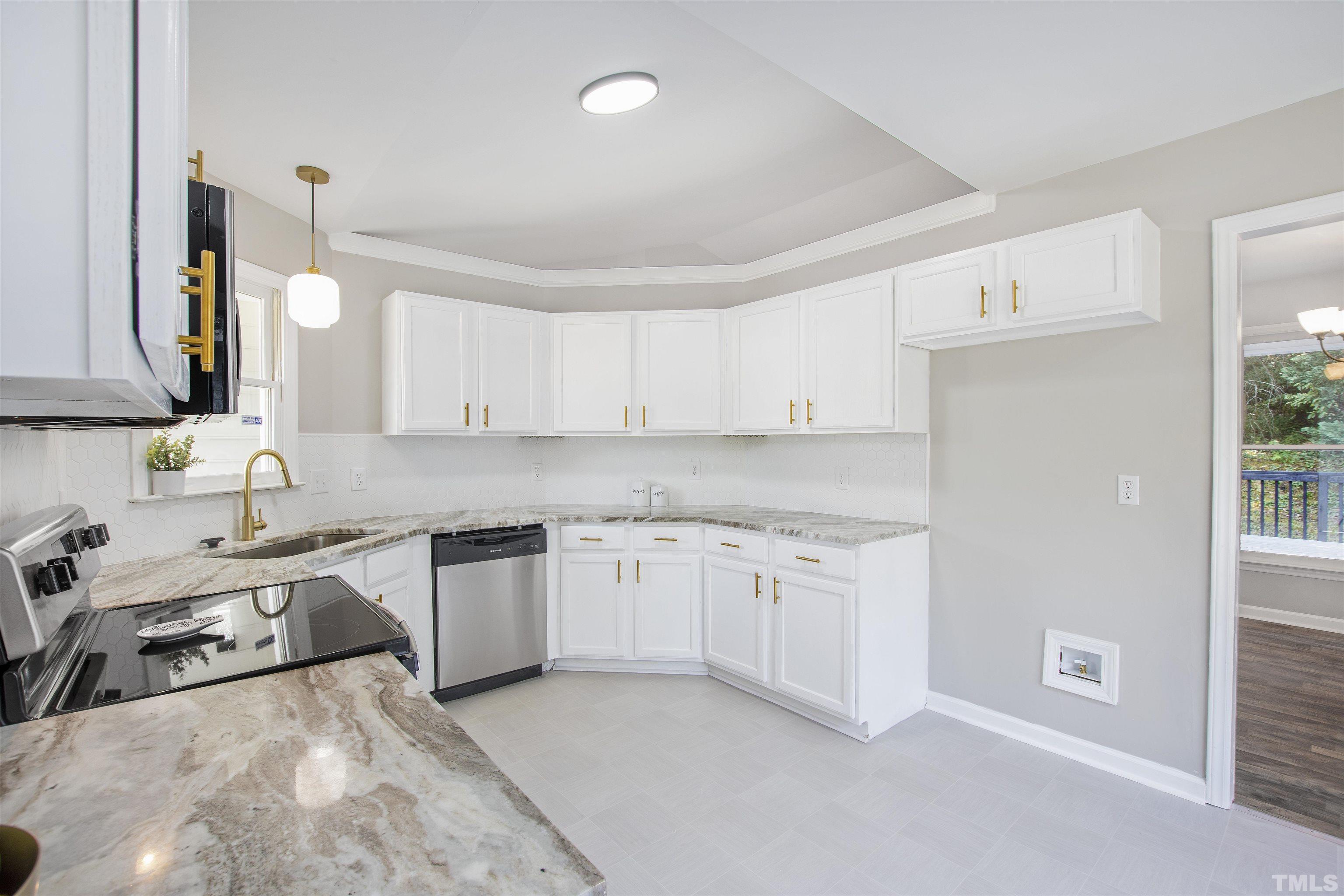 2109 Cardhu Way Raleigh, NC 27603 - Photo 26 of 40 a kitchen with a sink stove and cabinets