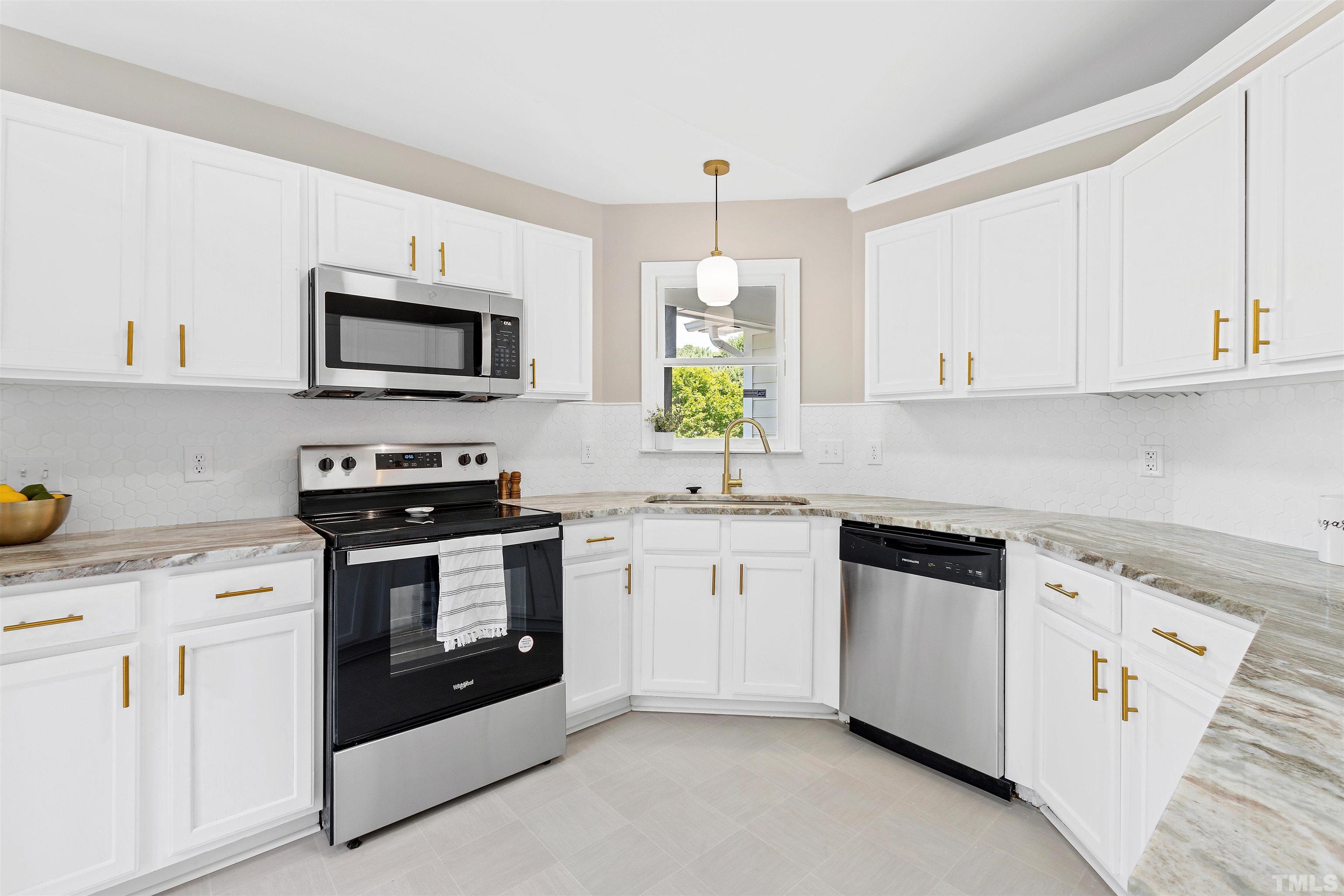 2109 Cardhu Way Raleigh, NC 27603 - Photo 27 of 40 a kitchen with cabinets stainless steel appliances and wooden cabinets