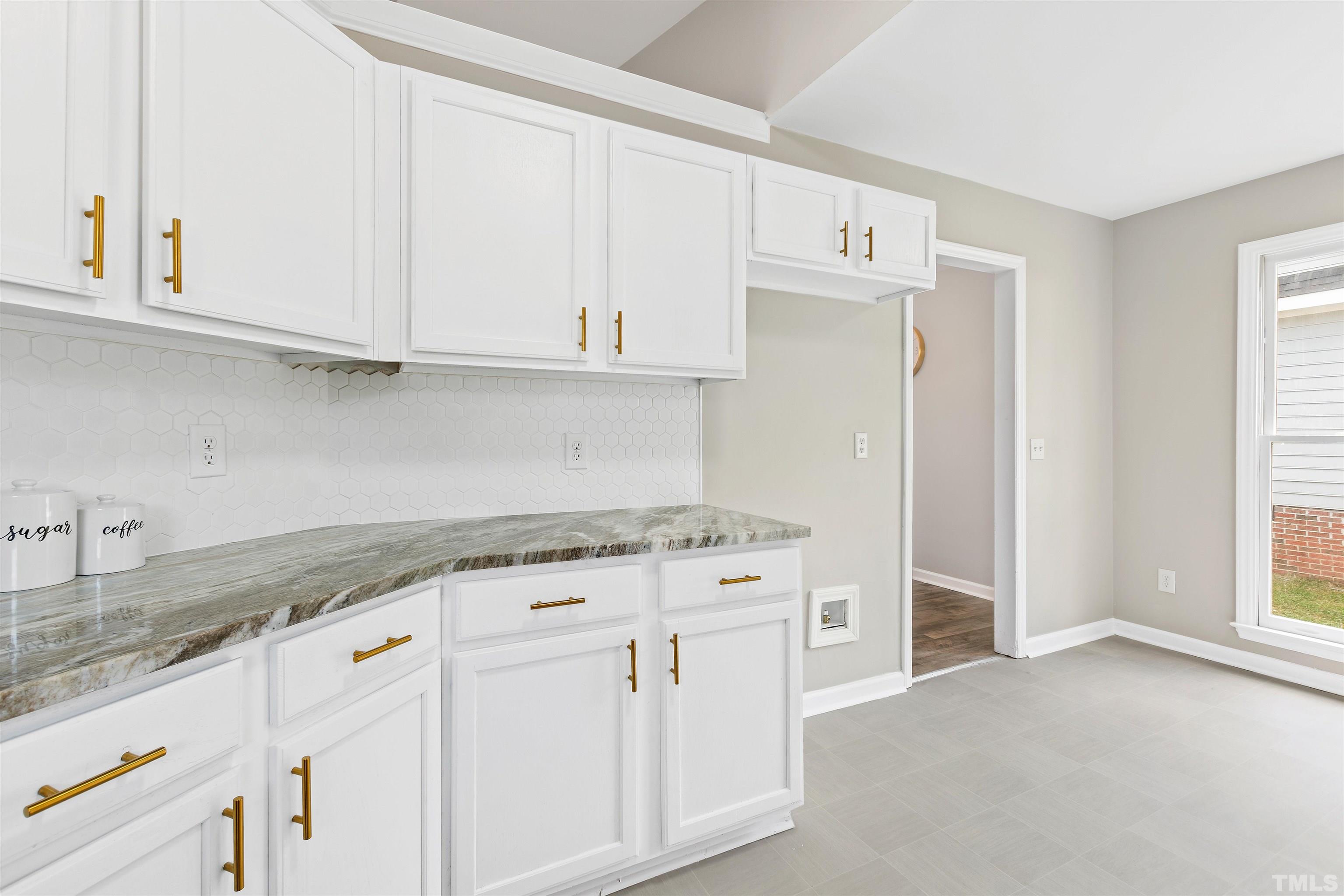 2109 Cardhu Way Raleigh, NC 27603 - Photo 30 of 40 a kitchen with granite countertop white cabinets and white appliances