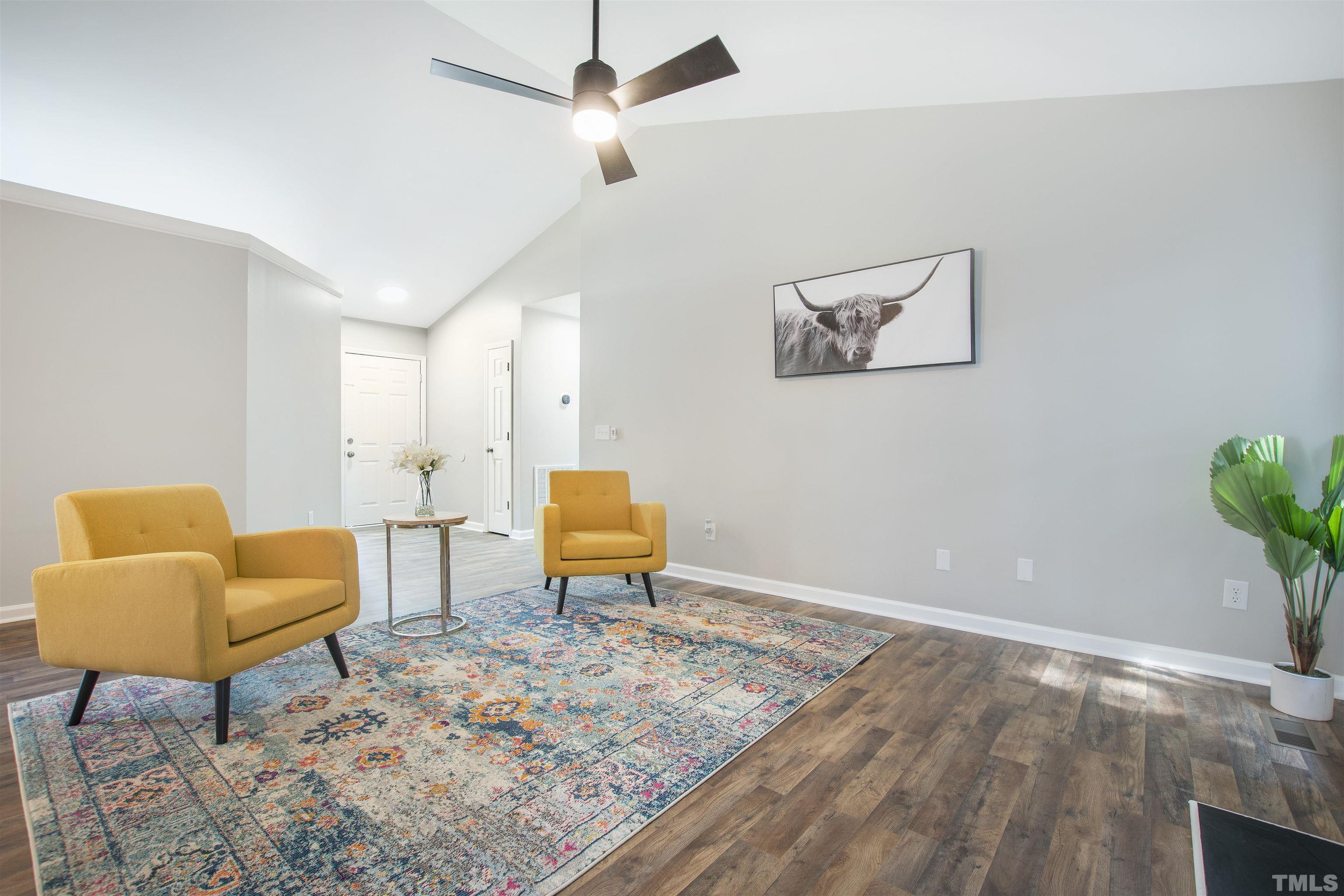2109 Cardhu Way Raleigh, NC 27603 - Photo 33 of 40 a living room with furniture and a wooden floor