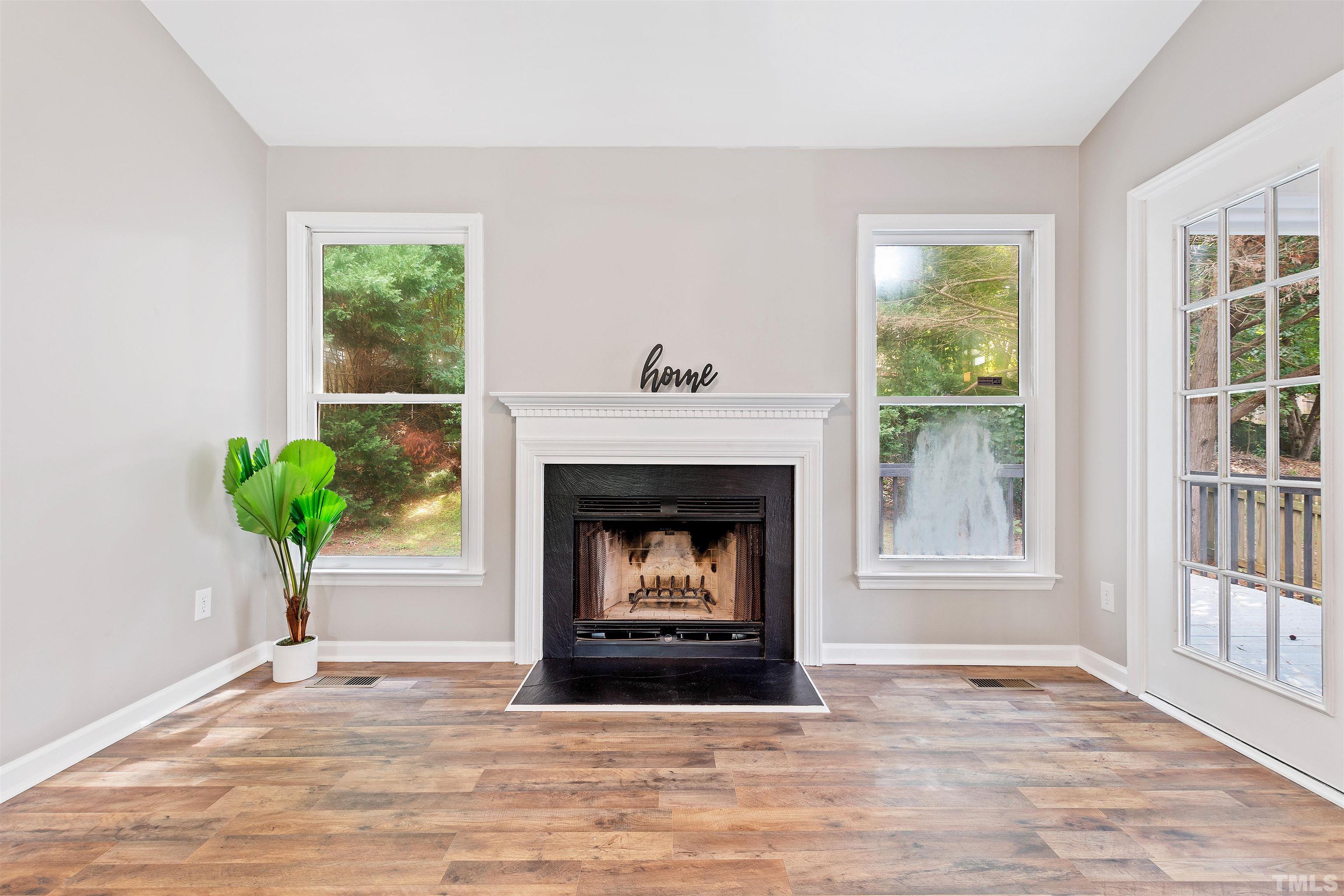 2109 Cardhu Way Raleigh, NC 27603 - Photo 37 of 40 a living room with a fireplace with wooden floor