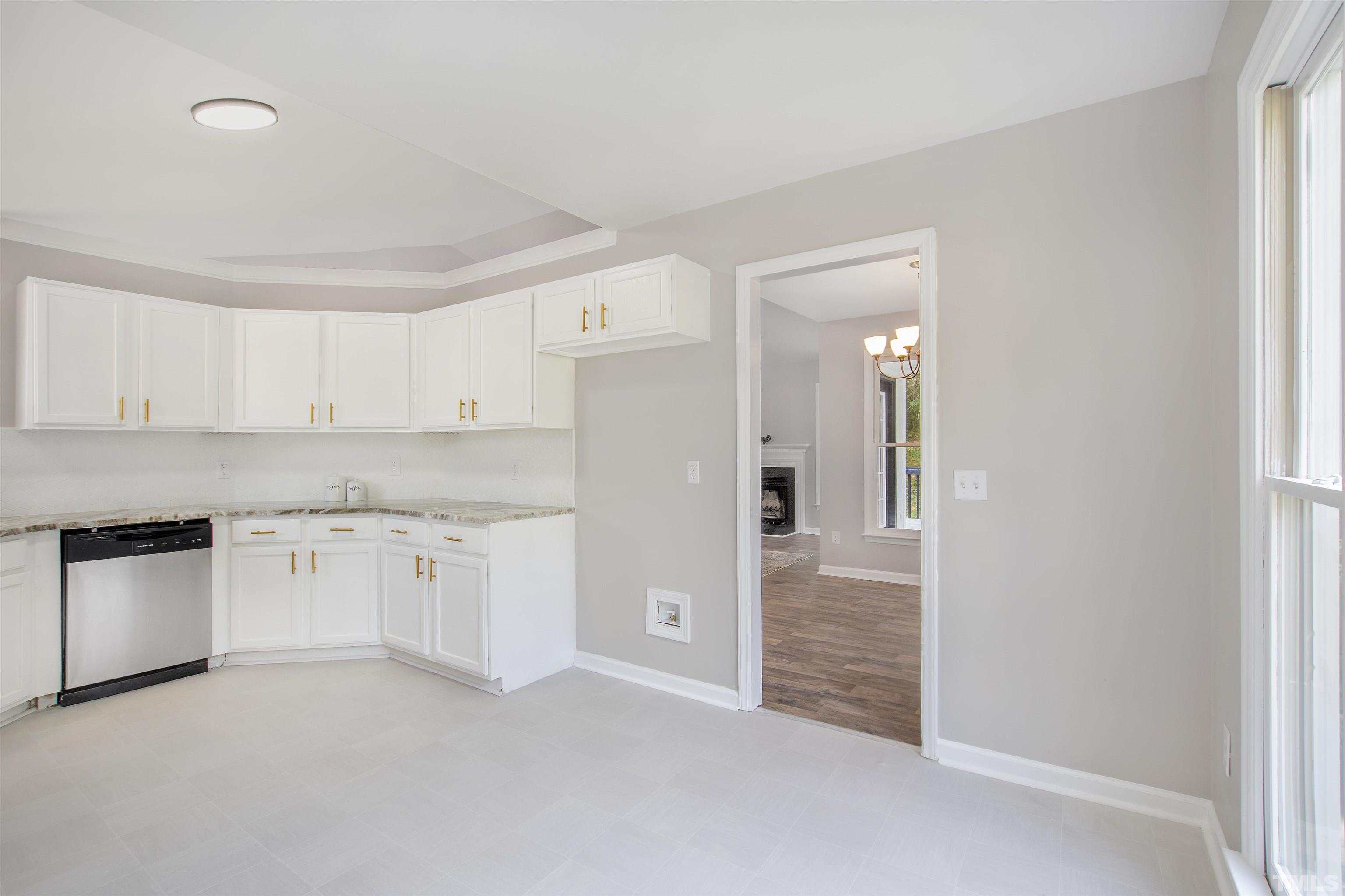 2109 Cardhu Way Raleigh, NC 27603 - Photo 38 of 40 a kitchen with granite countertop white cabinets and stainless steel appliances