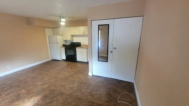 a view of a kitchen with a sink and refrigerator