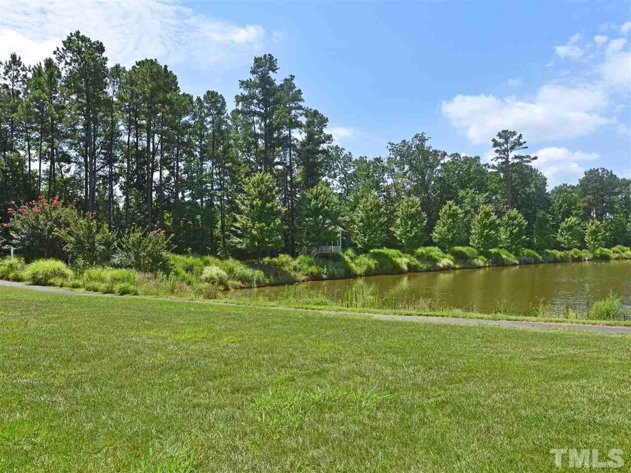 10411 Rosegate Court, Unit 5 Raleigh, NC 27617 - Photo 13 of 24 a view of a lake with a yard