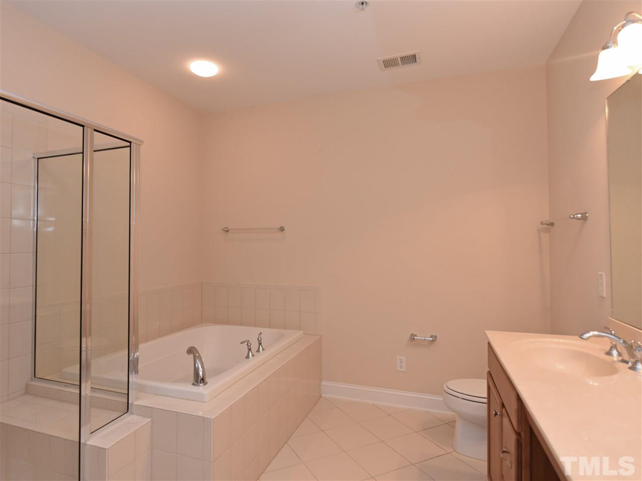 10411 Rosegate Court, Unit 5 Raleigh, NC 27617 - Photo 15 of 24 a bathroom with a sink a toilet and shower