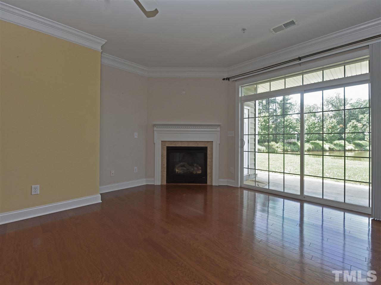 10411 Rosegate Court, Unit 5 Raleigh, NC 27617 - Photo 5 of 24 a view of an empty room with wooden floor and a window