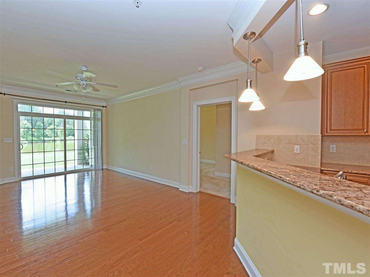10411 Rosegate Court, Unit 5 Raleigh, NC 27617 - Photo 6 of 24 a view of a kitchen with a sink and dishwasher with wooden floor