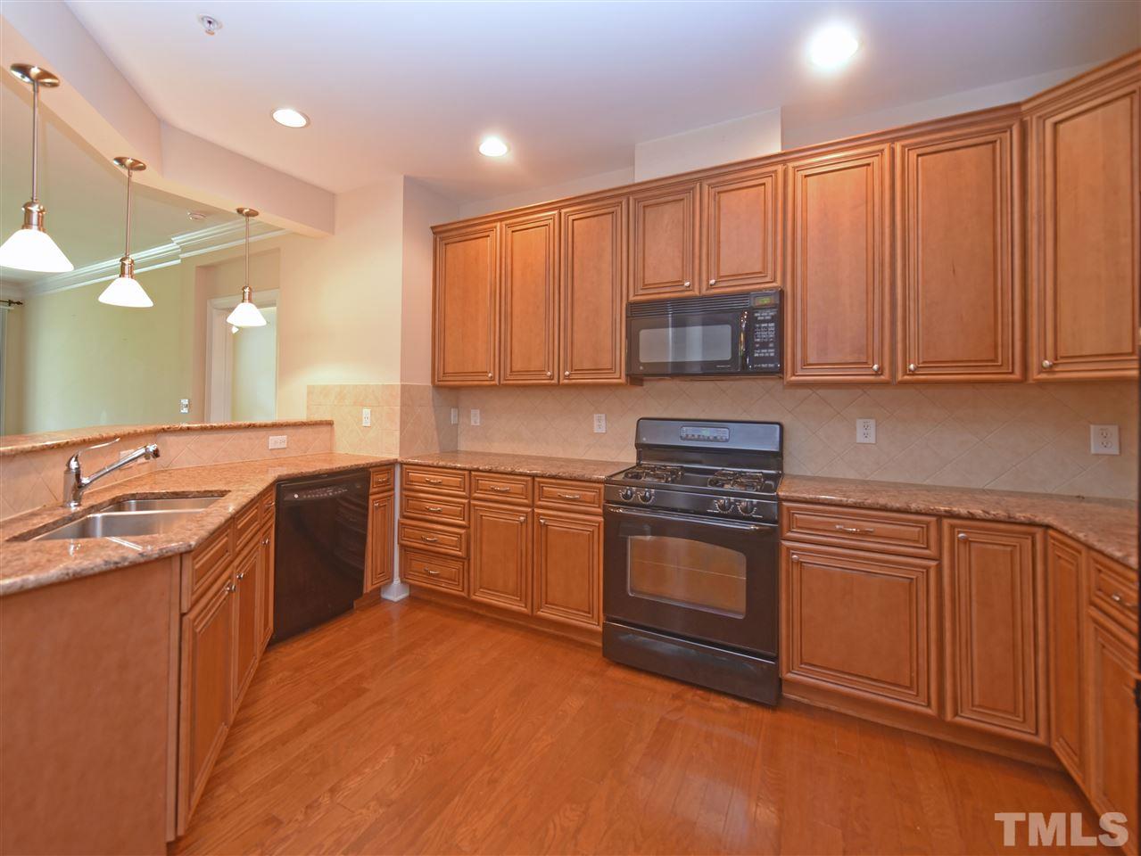 10411 Rosegate Court, Unit 5 Raleigh, NC 27617 - Photo 7 of 24 a kitchen with a sink stove and cabinets