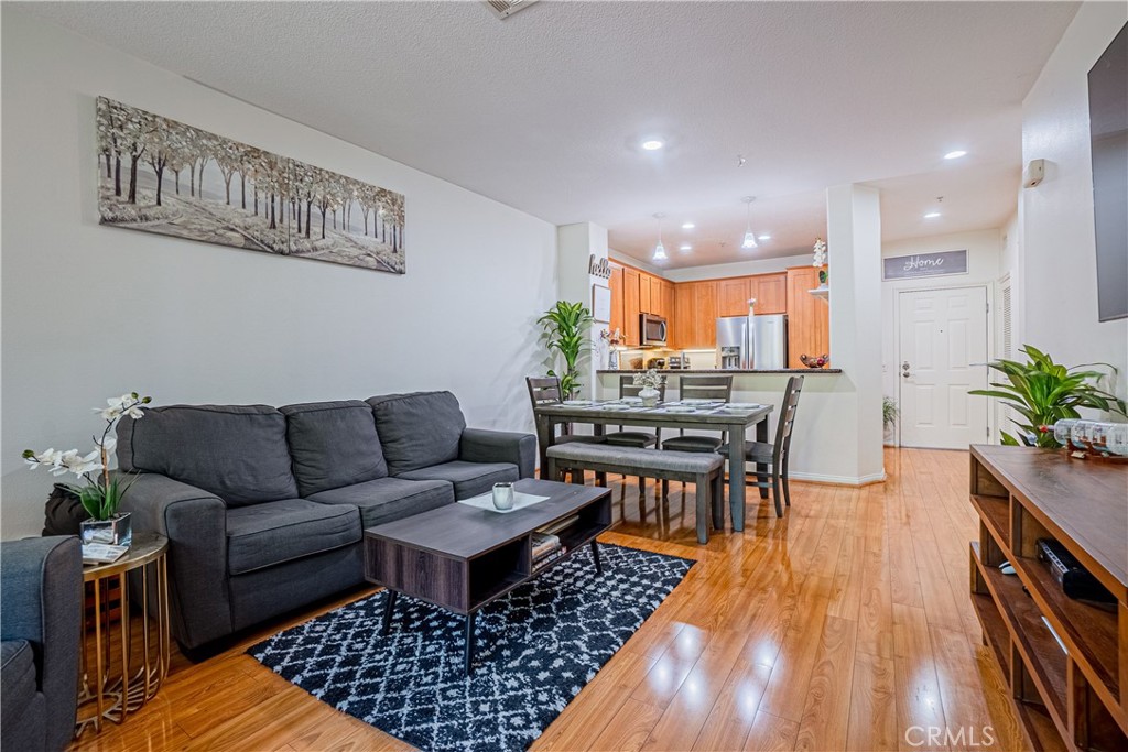 12668 Chapman Avenue, Unit 2108 Garden Grove, CA 92840 - Photo 1 of 40 a living room with furniture and a wooden floor