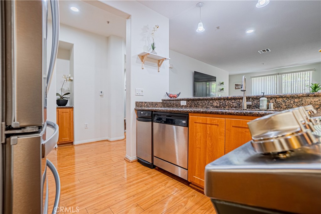 12668 Chapman Avenue, Unit 2108 Garden Grove, CA 92840 - Photo 11 of 40 a kitchen with stainless steel appliances granite countertop a sink counter space cabinets and a window