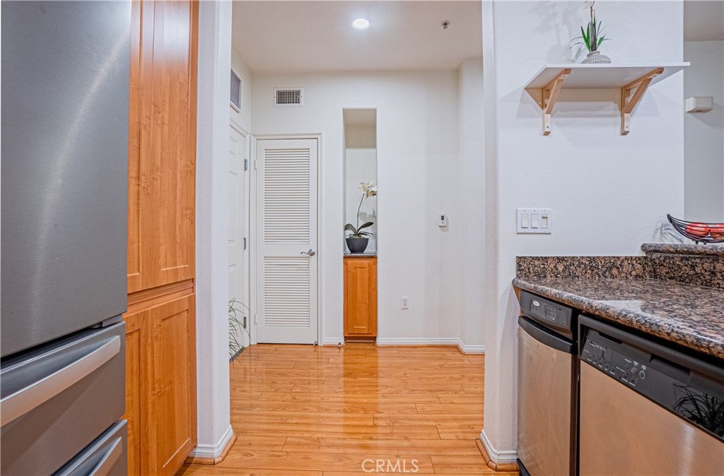 12668 Chapman Avenue, Unit 2108 Garden Grove, CA 92840 - Photo 13 of 40 a kitchen with stainless steel appliances granite countertop a refrigerator and a stove