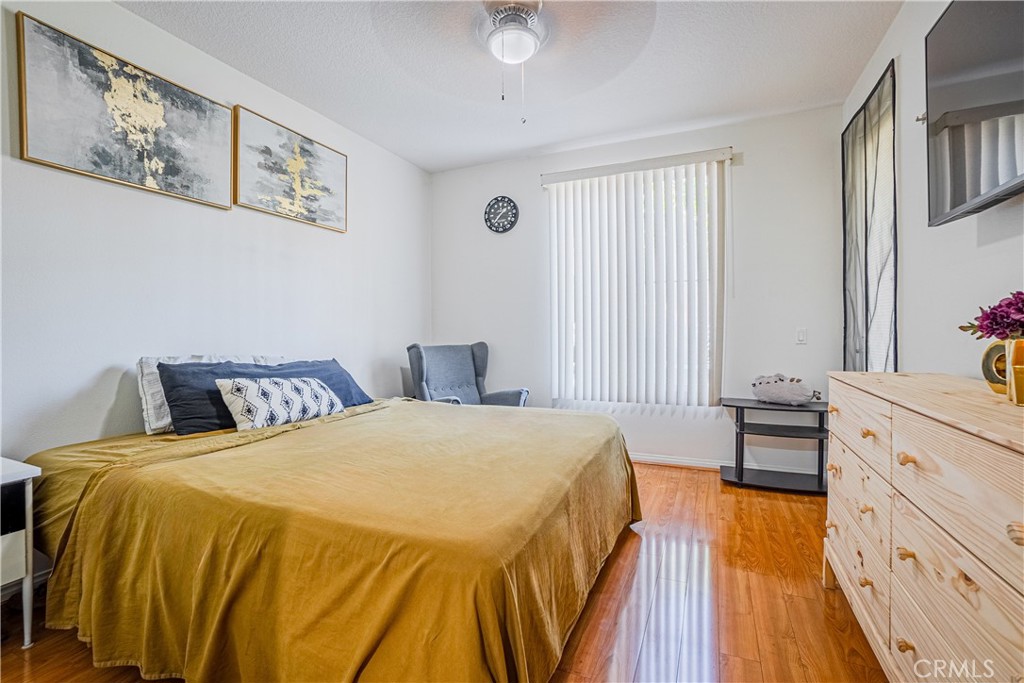 12668 Chapman Avenue, Unit 2108 Garden Grove, CA 92840 - Photo 14 of 40 a spacious bedroom with a bed and a dresser