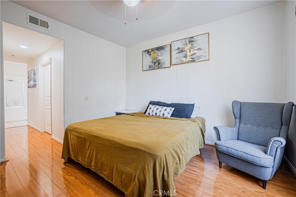 12668 Chapman Avenue, Unit 2108 Garden Grove, CA 92840 - Photo 15 of 40 a bedroom with a bed couch and a view of kitchen