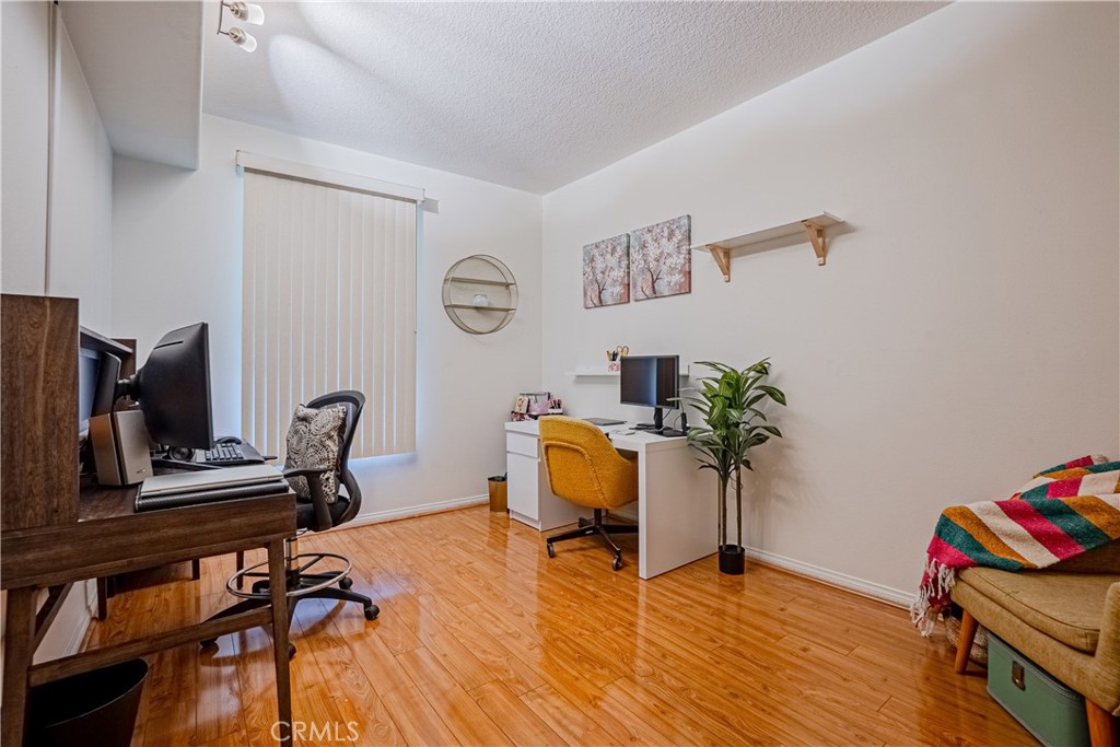 12668 Chapman Avenue, Unit 2108 Garden Grove, CA 92840 - Photo 20 of 40 a workspace with furniture and wooden floor