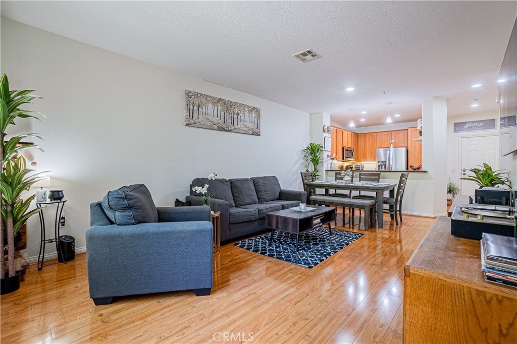 12668 Chapman Avenue, Unit 2108 Garden Grove, CA 92840 - Photo 2 of 40 a living room with furniture and a wooden floor