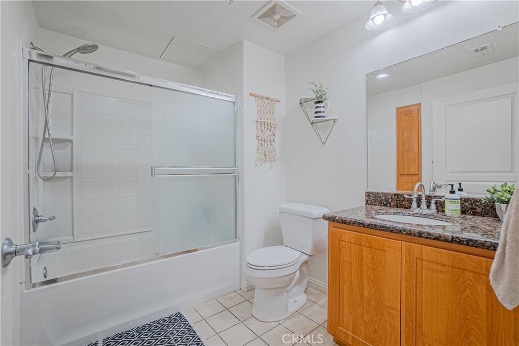 12668 Chapman Avenue, Unit 2108 Garden Grove, CA 92840 - Photo 23 of 40 a bathroom with a granite countertop sink toilet and shower