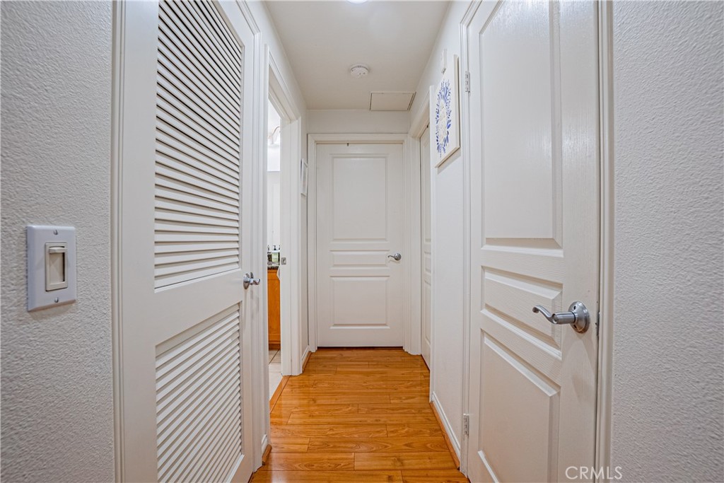 12668 Chapman Avenue, Unit 2108 Garden Grove, CA 92840 - Photo 26 of 40 a view of a hallway with wooden floor and staircase