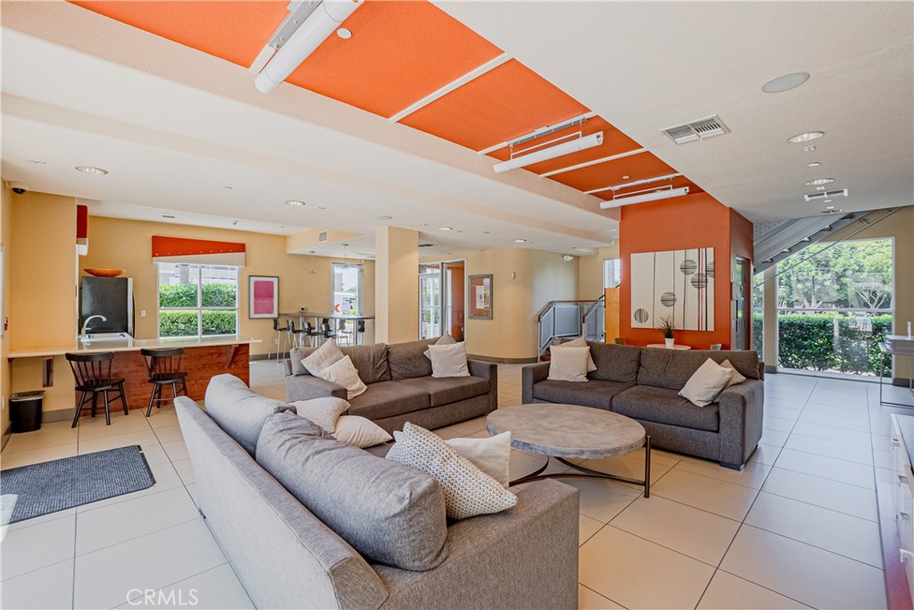 12668 Chapman Avenue, Unit 2108 Garden Grove, CA 92840 - Photo 33 of 40 a living room with furniture a large window and a rug