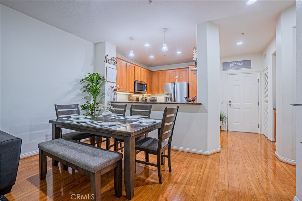 12668 Chapman Avenue, Unit 2108 Garden Grove, CA 92840 - Photo 7 of 40 a view of a dining room with furniture and wooden floor