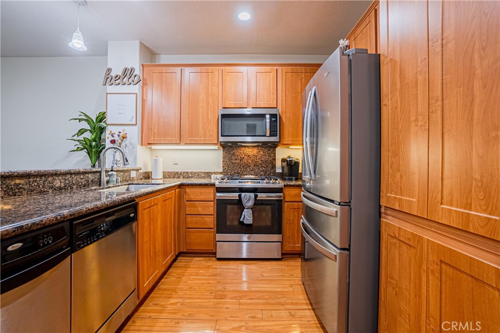 12668 Chapman Avenue, Unit 2108 Garden Grove, CA 92840 - Photo 9 of 40 a kitchen with granite countertop stainless steel appliances and counter space
