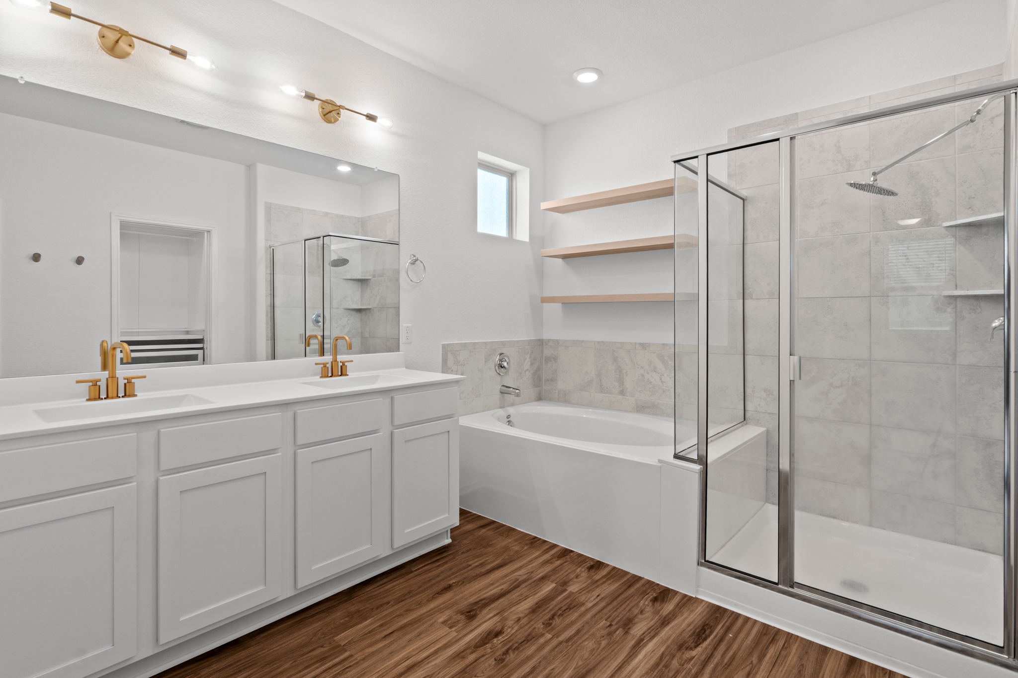 1101 Skeeter Cove Austin, TX 78748 - Photo 15 of 31 Indulge in a tranquil primary bathroom, featuring a dual vanity, deep soaking tub, and spacious glass-enclosed shower.