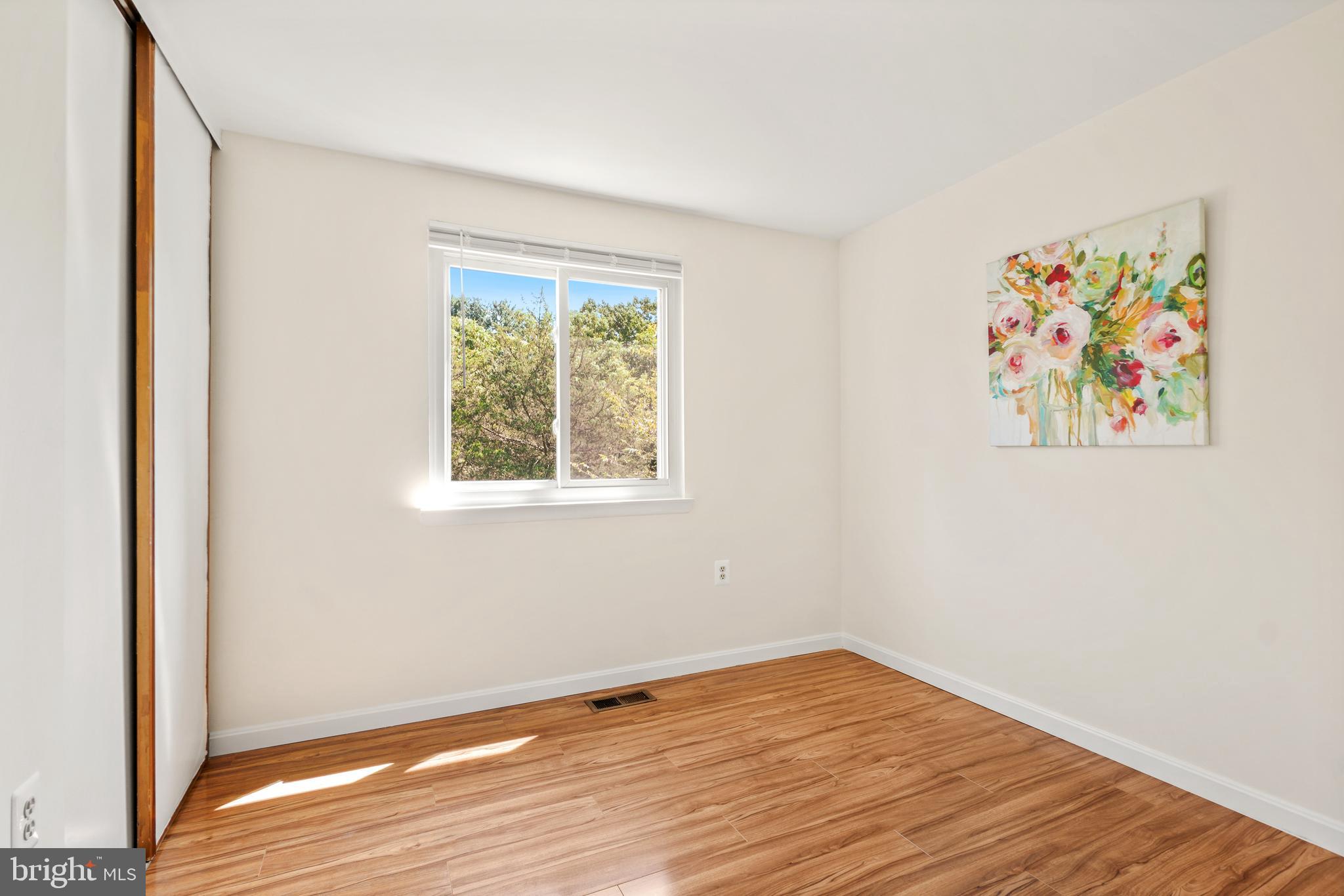 8900 Centerway Road Gaithersburg, MD 20879 - Photo 17 of 32 a view of an empty room with wooden floor and a window