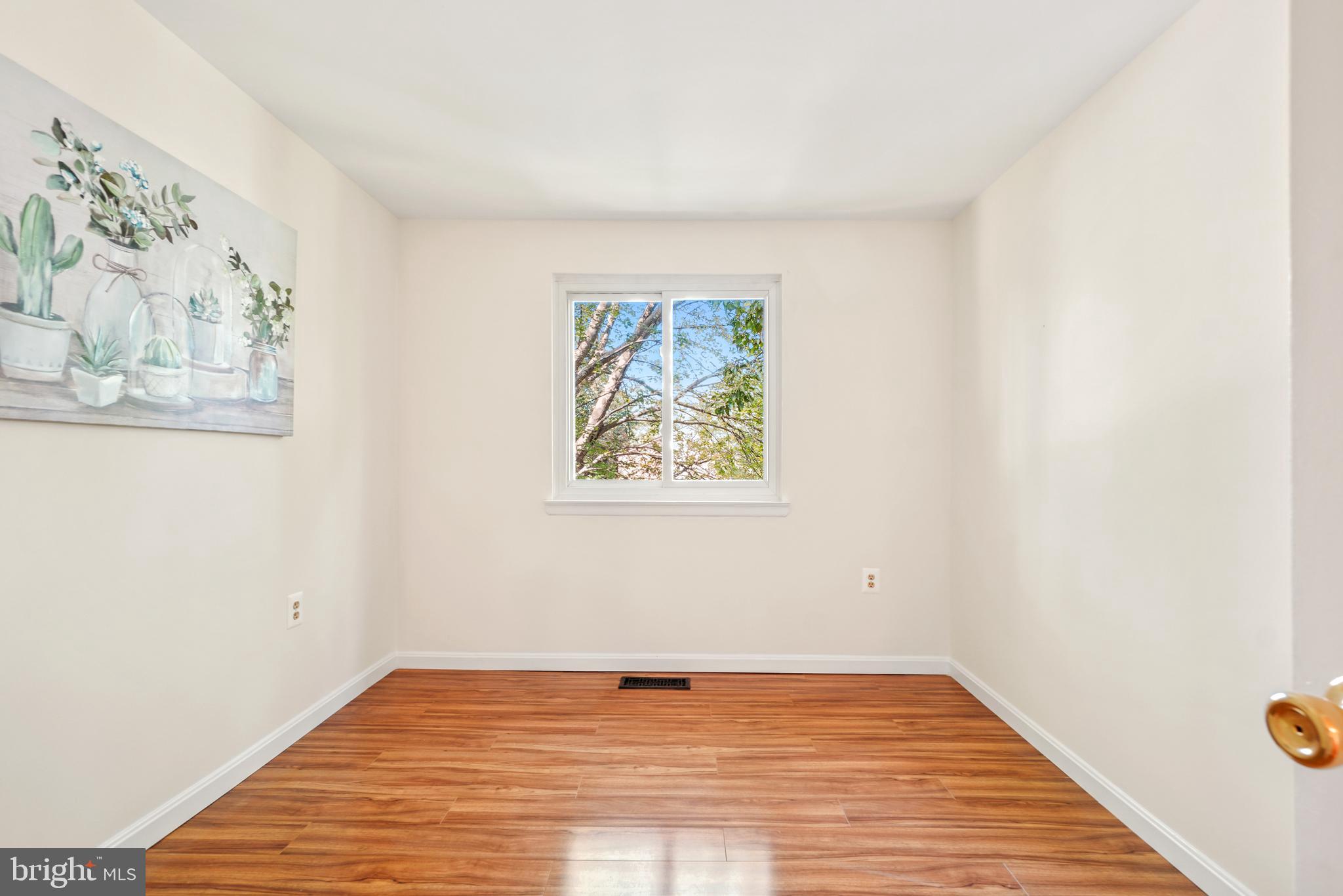 8900 Centerway Road Gaithersburg, MD 20879 - Photo 20 of 32 a view of an empty room with wooden floor and a window